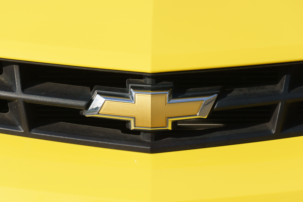 yellow car close up on chevy logo